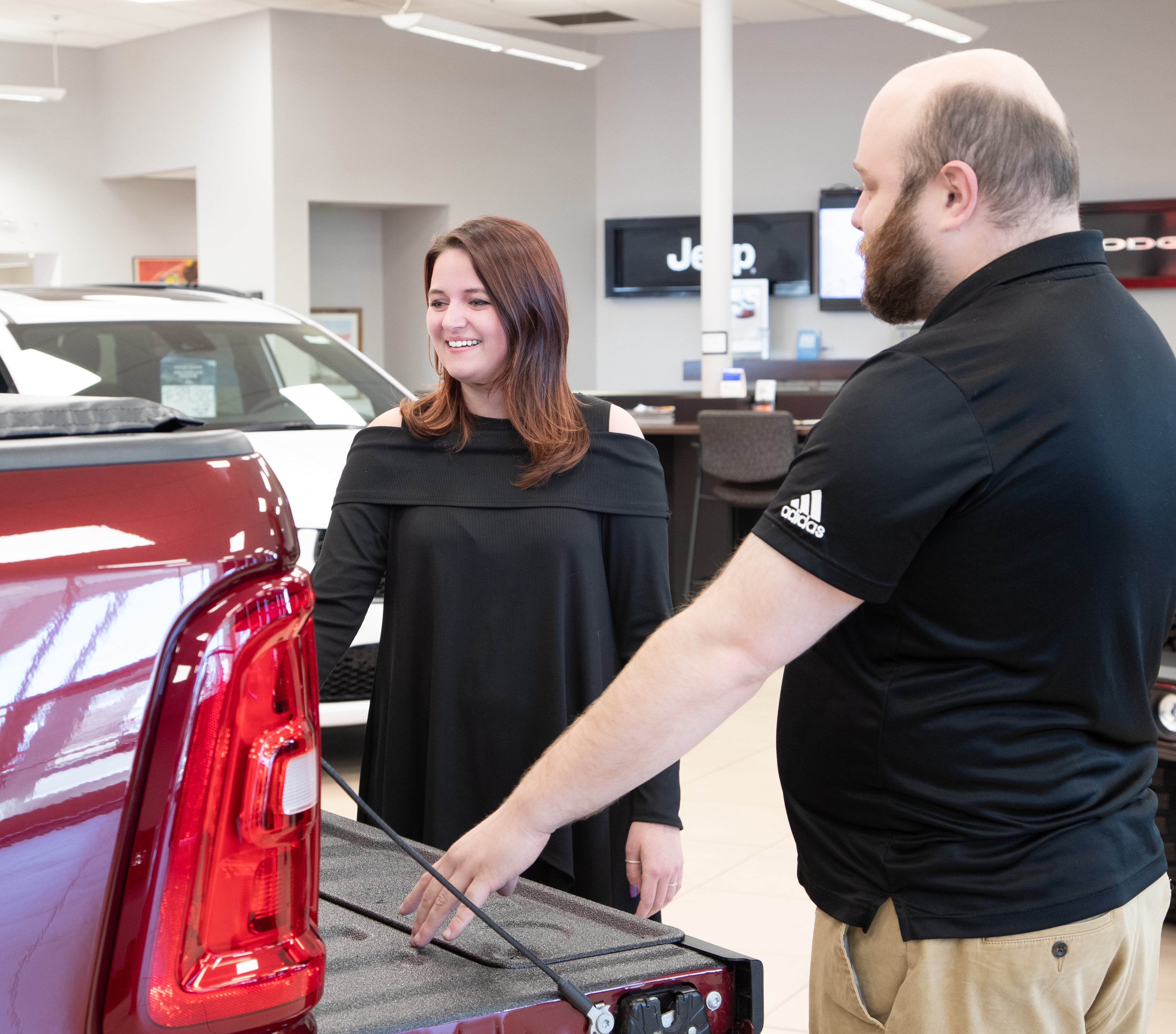 Salesperson showing a vehicle on the showfloor